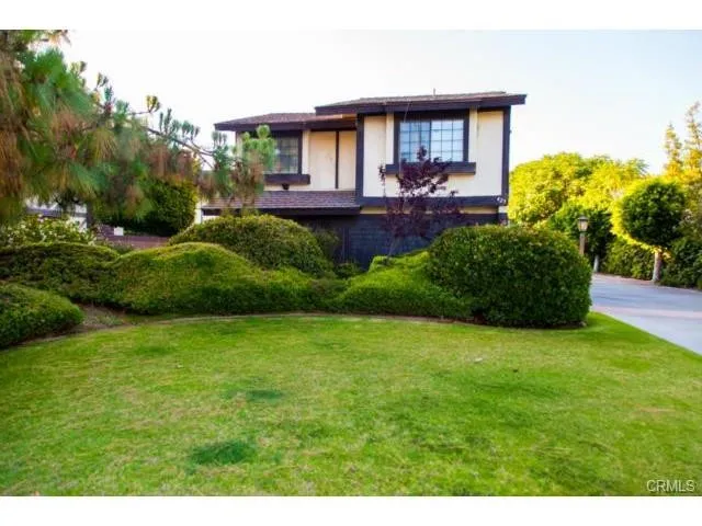 a view of a house with a backyard and a patio