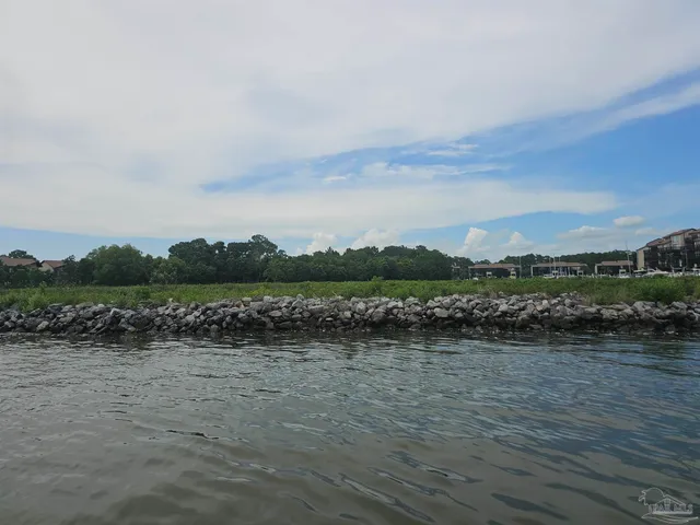 a view of a lake with houses in the back