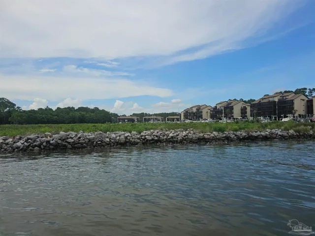 a view of a lake with houses in the back
