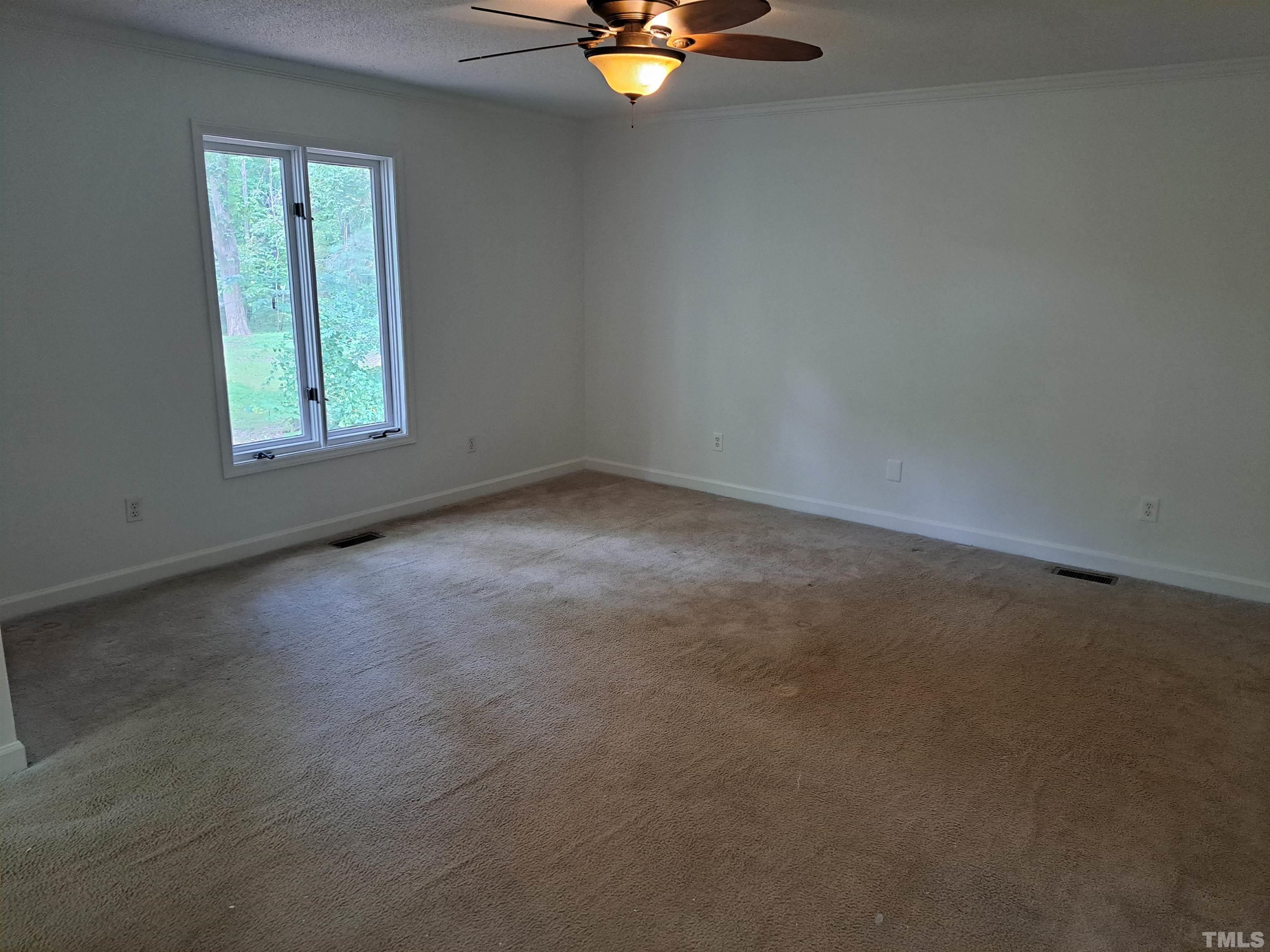7313 Martin Road Zebulon, NC 27597 - Photo 11 of 19 an empty room with a window