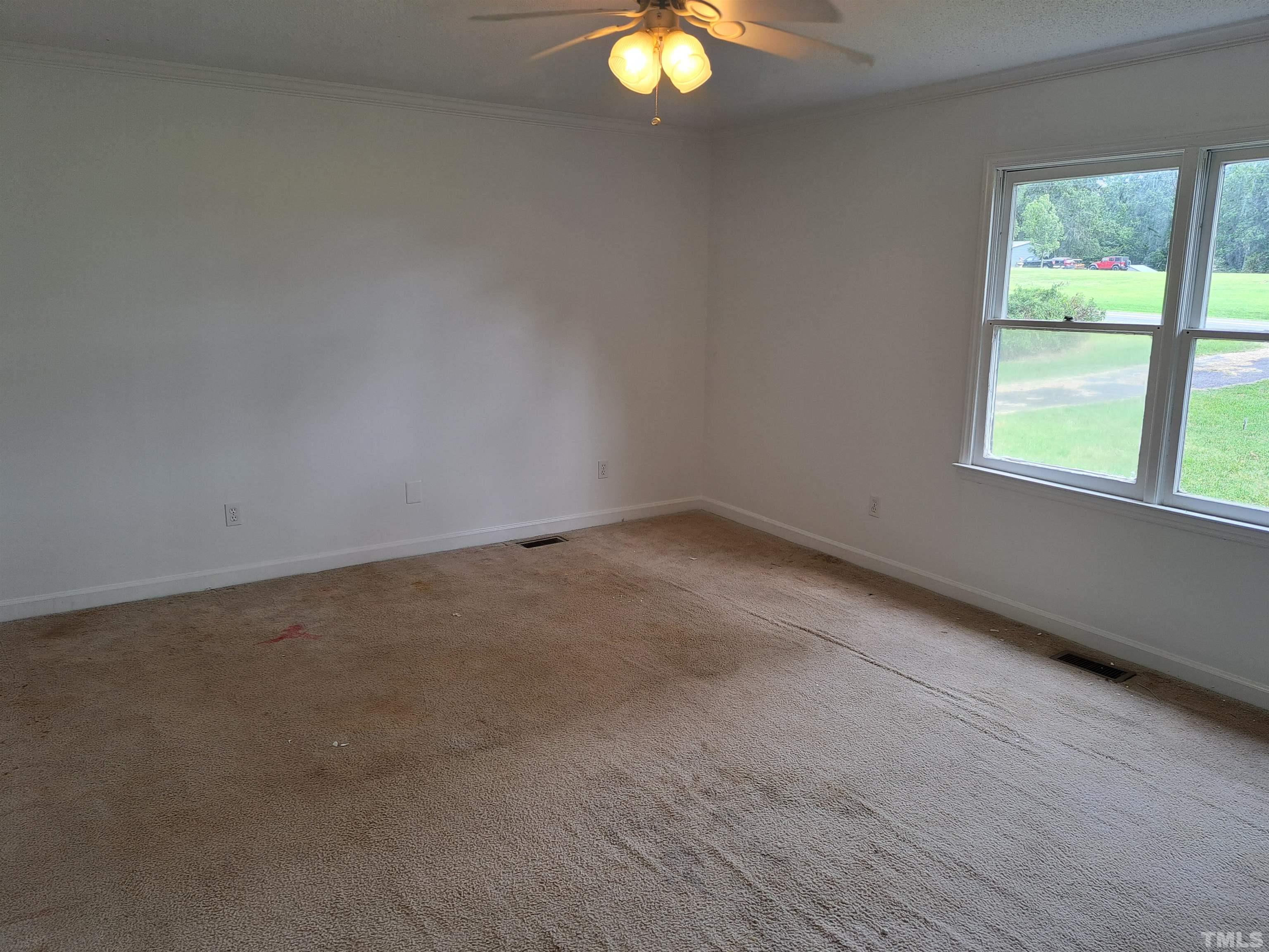 7313 Martin Road Zebulon, NC 27597 - Photo 10 of 19 an empty room with a window