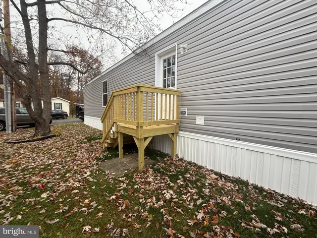 a blue and white bench sitting in front of a house
