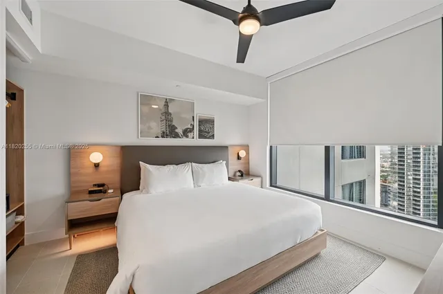 a bedroom with a bed and a large window