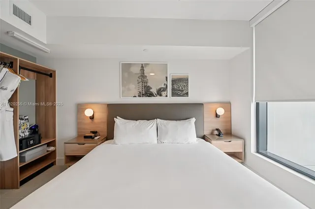 a bedroom with a bed and a tv