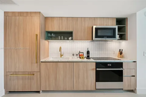 a kitchen with stainless steel appliances granite countertop a stove and a microwave