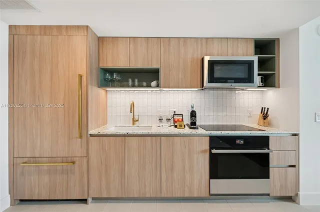 a kitchen with stainless steel appliances granite countertop a stove and a microwave