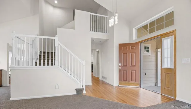 a view of staircase with white walls and windows