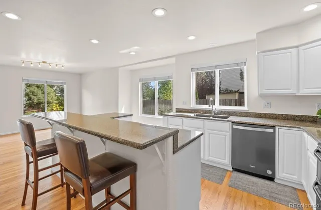 a kitchen with a table chairs sink and cabinets