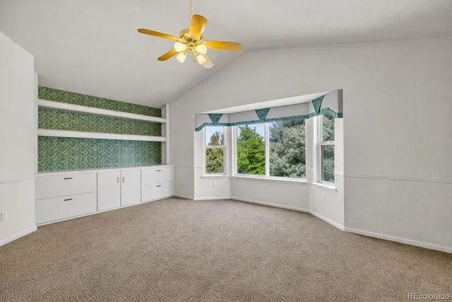 an empty room with windows and entrance