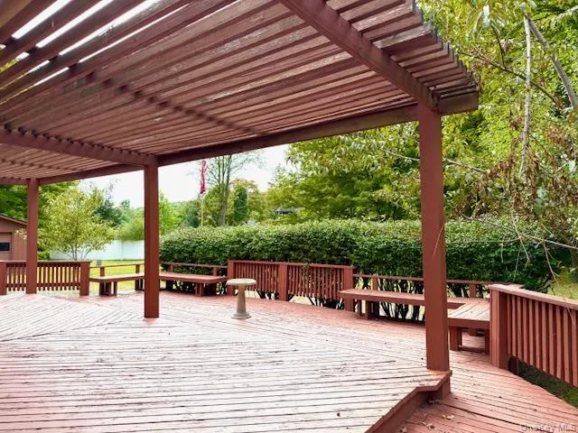 a balcony with wooden floor and outdoor seating