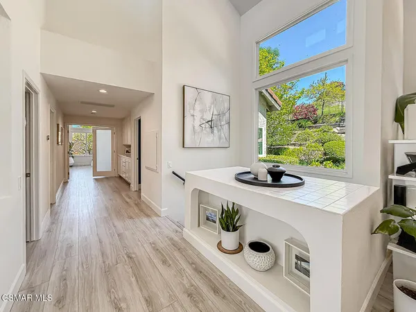 a kitchen with a stove and a wooden floor
