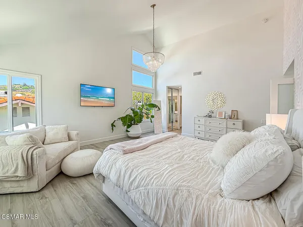 a bedroom with bed and a window