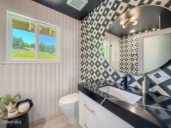 a bath room with a toilet and a shower curtain