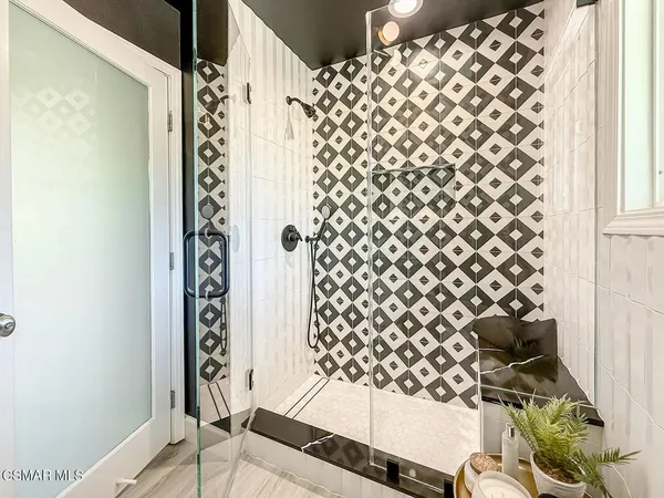 a bathroom with a bathtub and shower