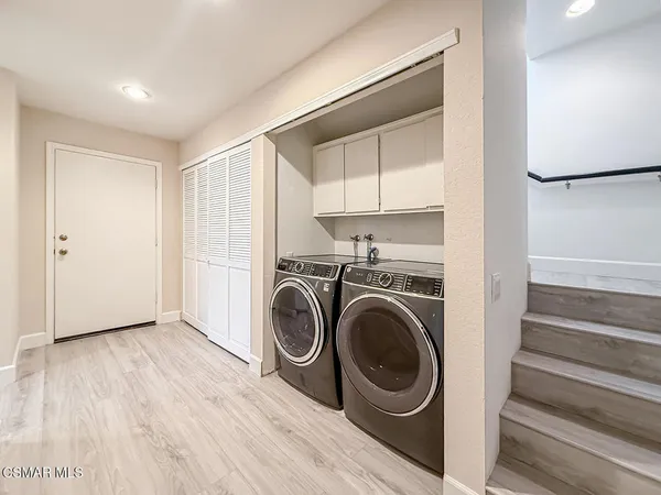 a view of a hallway with washer and dryer