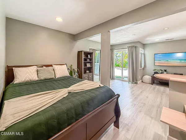a bedroom with a large bed and a large window
