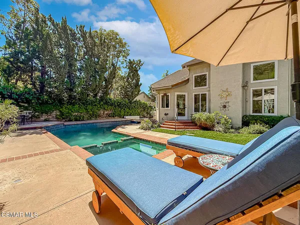 a view of swimming pool with chairs