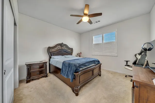 a bathroom with a double vanity sink a toilet and a mirror