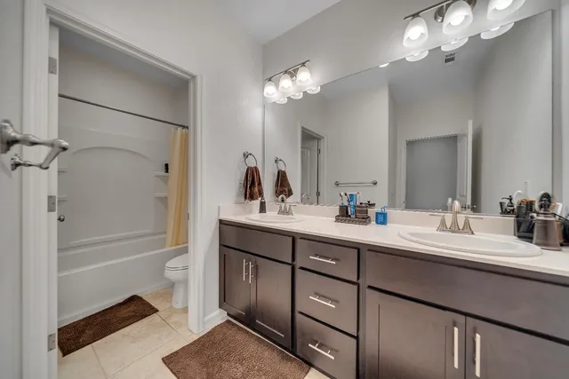a living room with lots of furniture and kitchen view