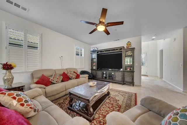 a view of a dining room with furniture a rug and wooden floor