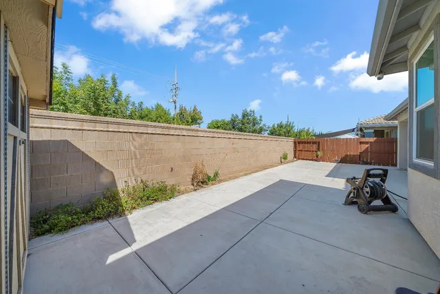 a living room with furniture a flat screen tv and kitchen view