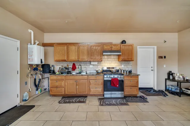 a kitchen with stainless steel appliances granite countertop a stove and cabinets