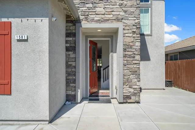 front view of a brick house with a outdoor space