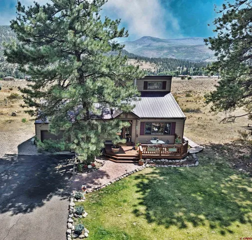 a view of a backyard with plants and outdoor seating