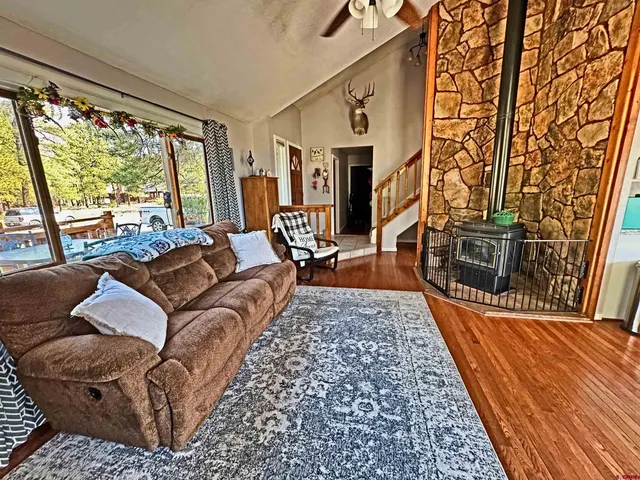 a living room with furniture wooden floor and a fireplace