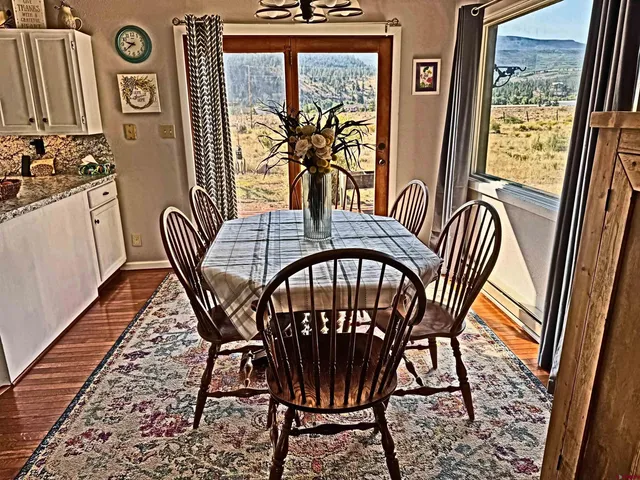 a view of a chairs and table in a balcony