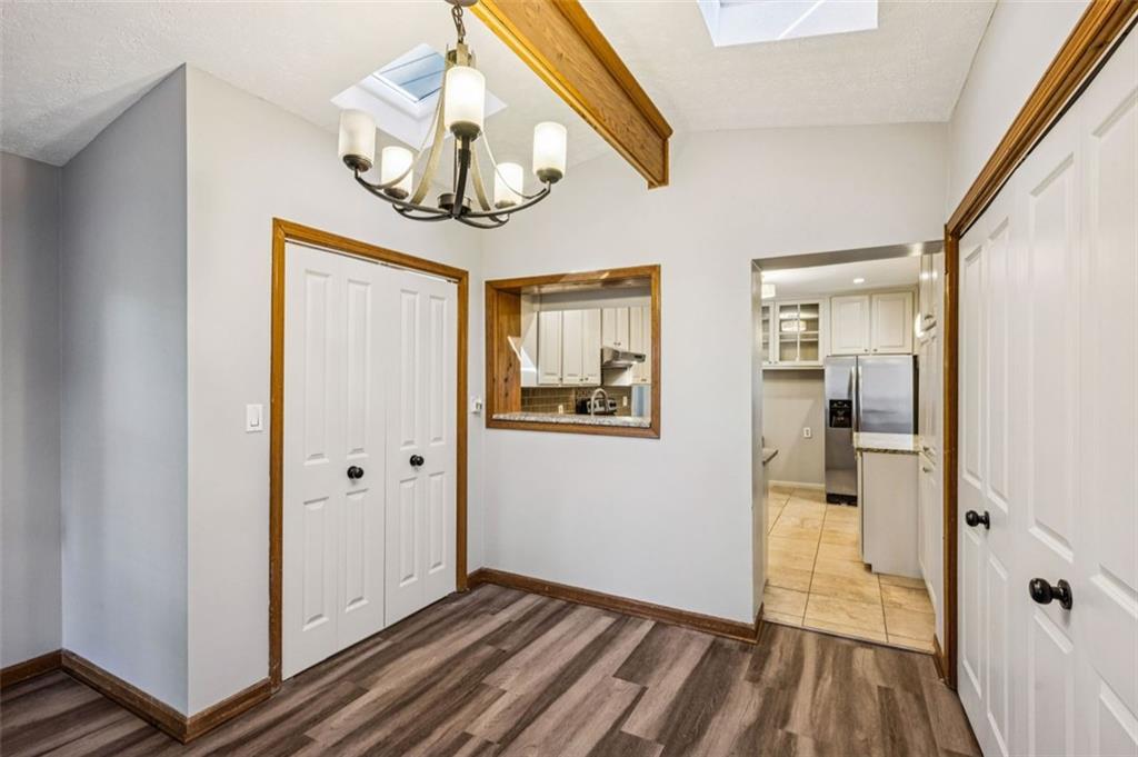 2050 Mercer Avenue Atlanta, GA 30337 - Photo 13 of 29 a view of a hallway with wooden floor and a bathroom