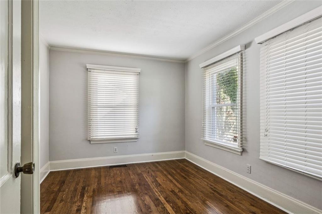 2050 Mercer Avenue Atlanta, GA 30337 - Photo 16 of 29 a view of an empty room with wooden floor and a window
