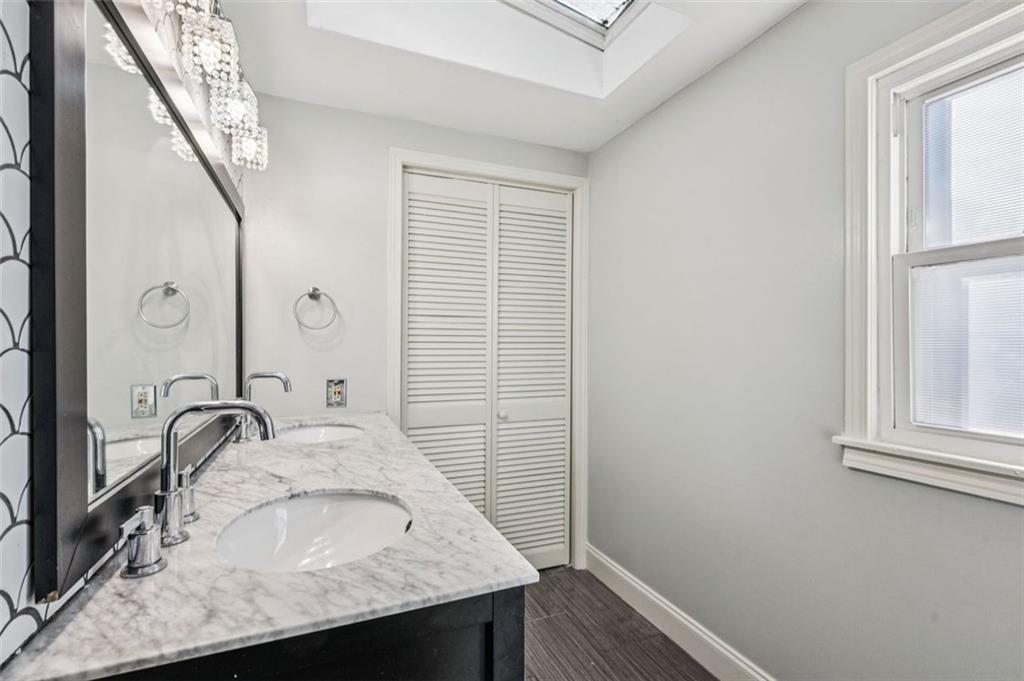 2050 Mercer Avenue Atlanta, GA 30337 - Photo 21 of 29 a bathroom with a granite countertop sink and a mirror