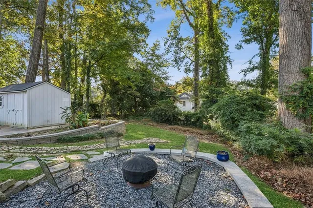 a backyard of a house with yard and trampoline