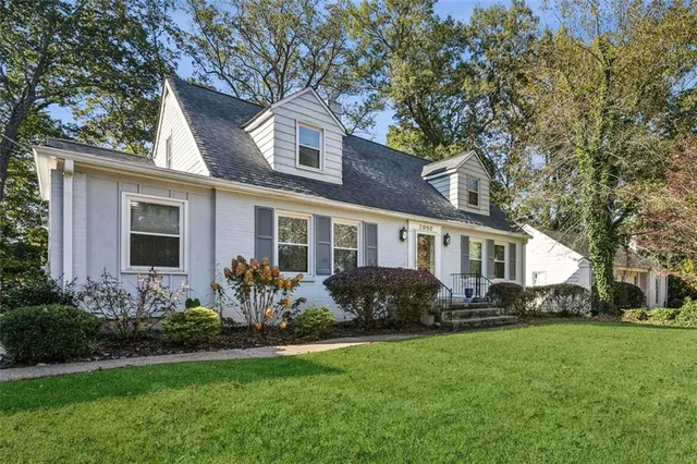 a front view of house with yard and green space