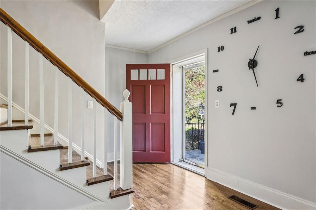 2050 Mercer Avenue Atlanta, GA 30337 - Photo 4 of 29 a view of staircase with lots of frames on wall and a window