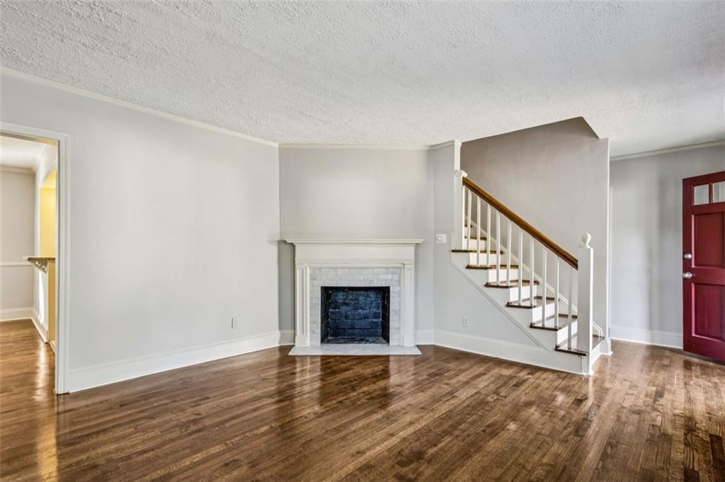 2050 Mercer Avenue Atlanta, GA 30337 - Photo 6 of 29 a view of an empty room with wooden floor fireplace and a window