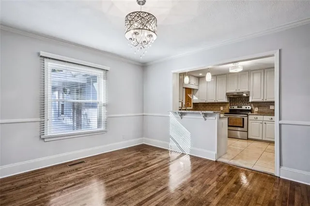 a kitchen with a refrigerator and a stove top oven