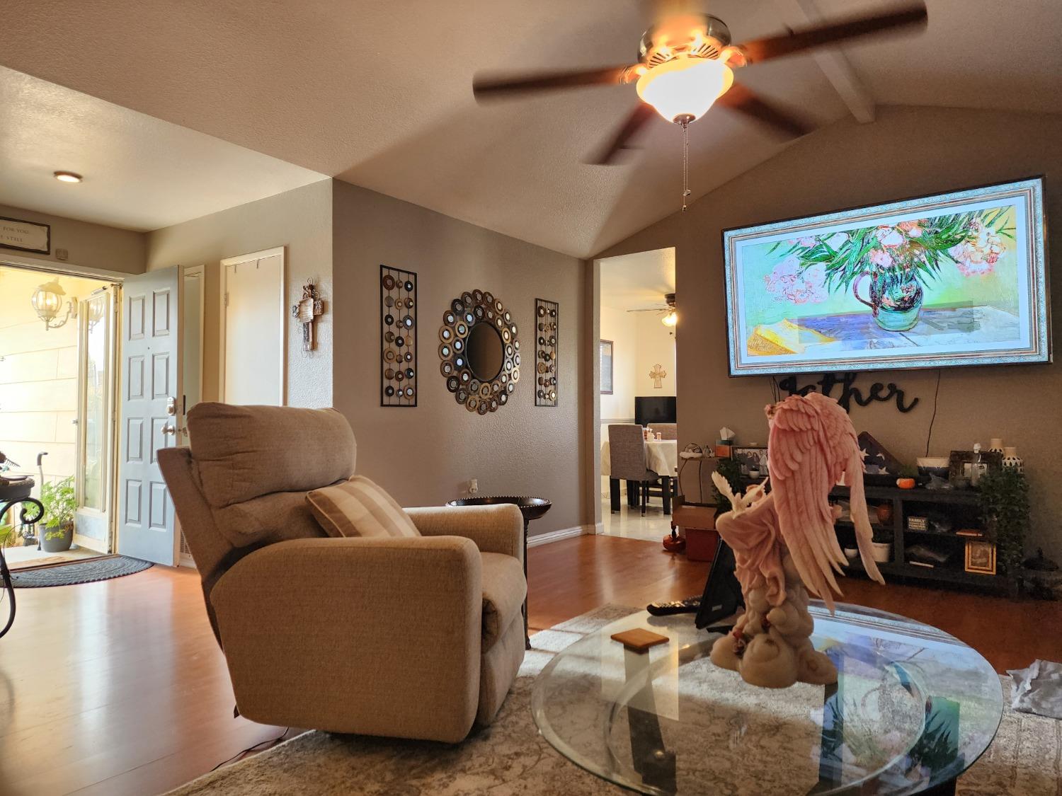1406 Quail Street Los Banos, CA 93635 - Photo 11 of 18 a living room with furniture a window and a flat screen tv