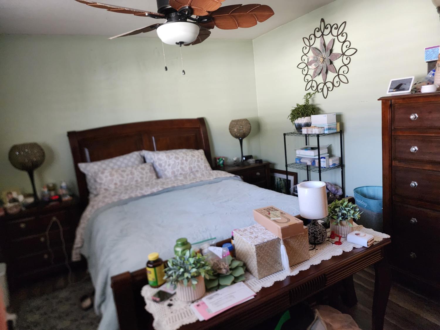 1406 Quail Street Los Banos, CA 93635 - Photo 18 of 18 a bedroom with a bed and a table