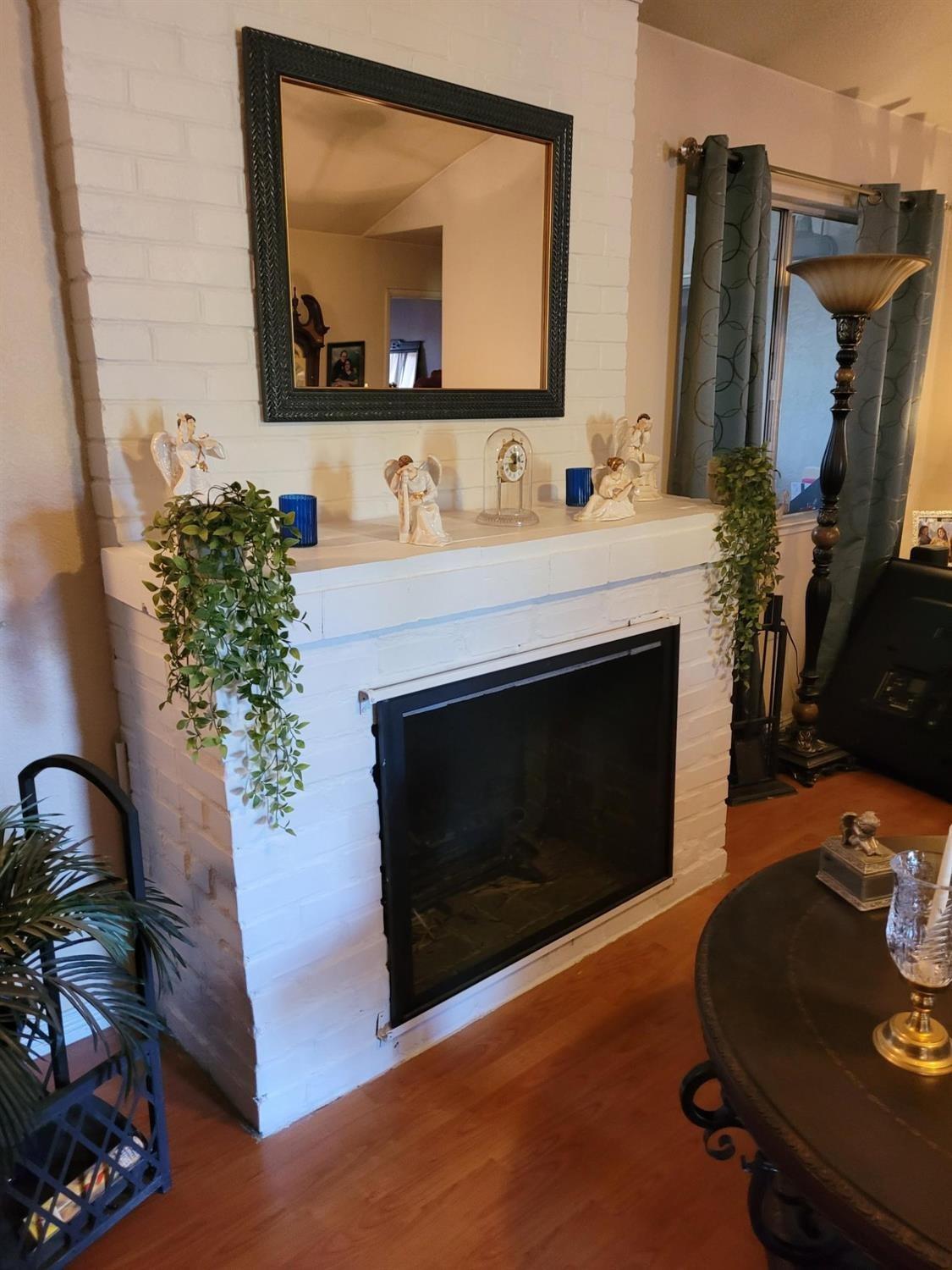 1406 Quail Street Los Banos, CA 93635 - Photo 2 of 18 a living room with furniture and a fireplace