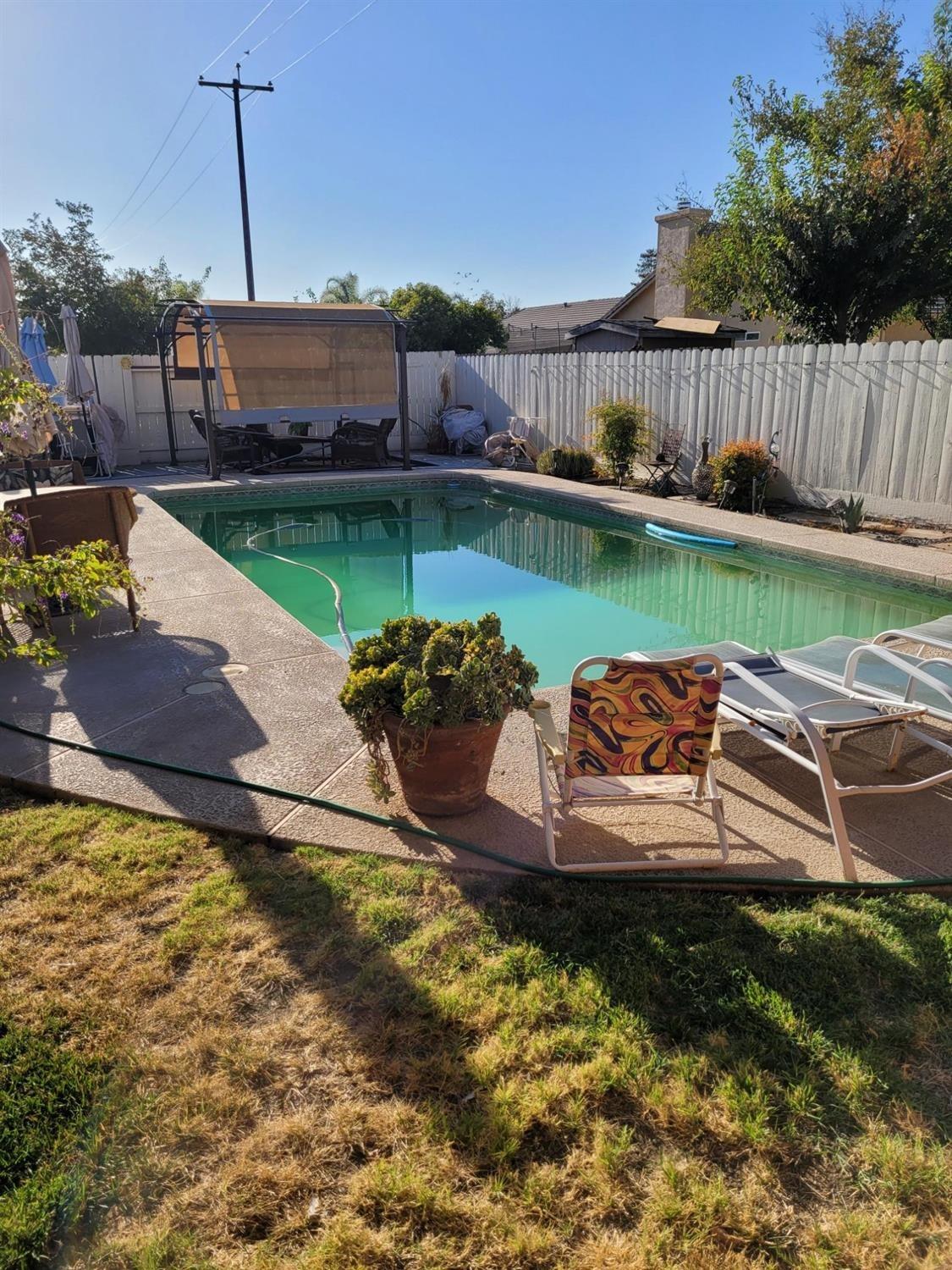1406 Quail Street Los Banos, CA 93635 - Photo 3 of 18 a view of a swimming pool with a patio