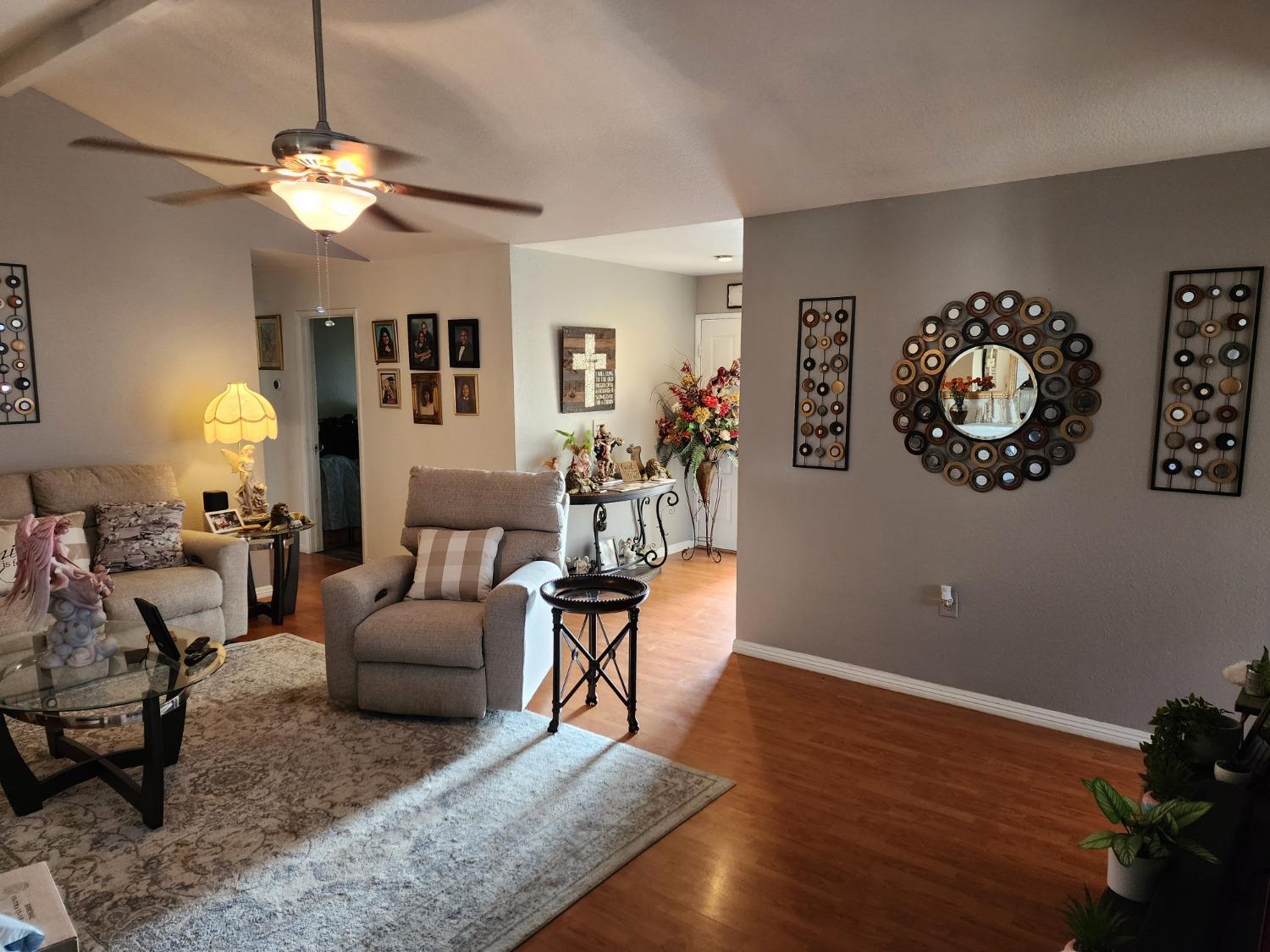 1406 Quail Street Los Banos, CA 93635 - Photo 7 of 18 a living room with furniture and a chandelier