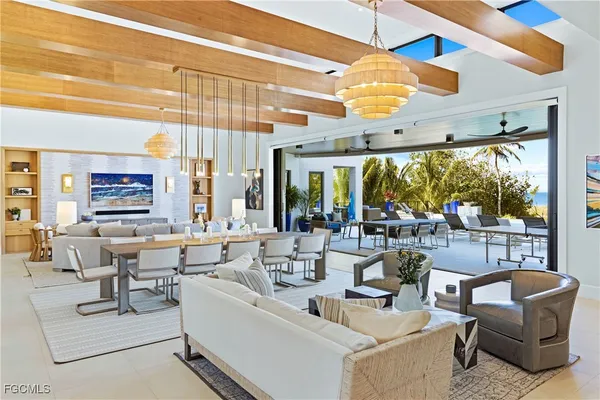 a living room with fireplace furniture and a large window