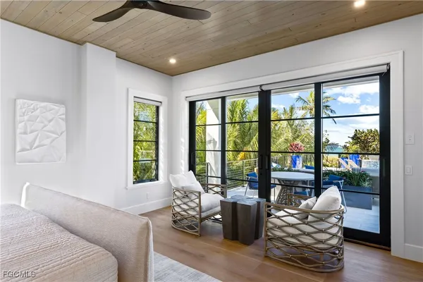 a living room with furniture and floor to ceiling windows