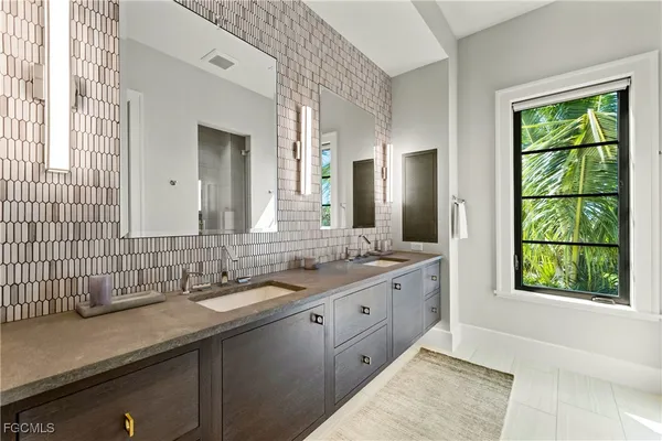 a bathroom with a double vanity sink and mirror