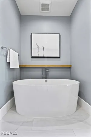 a white tub sitting in a bathroom