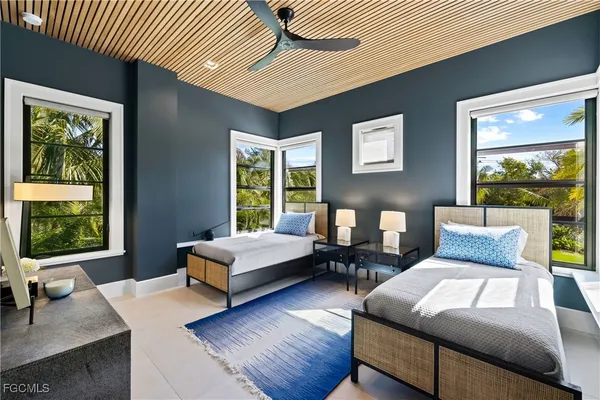 a bedroom with a bed wooden floor and window