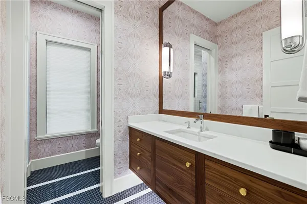 a bathroom with a sink and a mirror