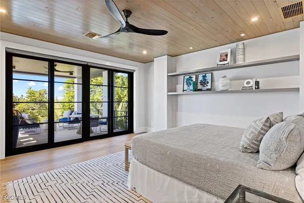 a bedroom with a large bed and a large window